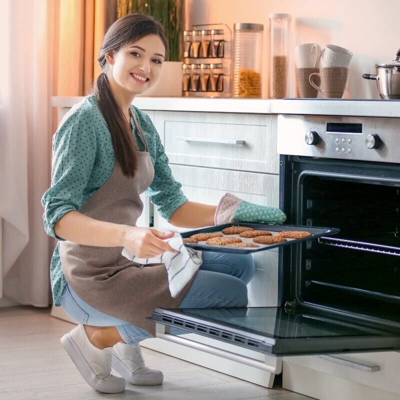 Pretty Women Baking Cookies in oven