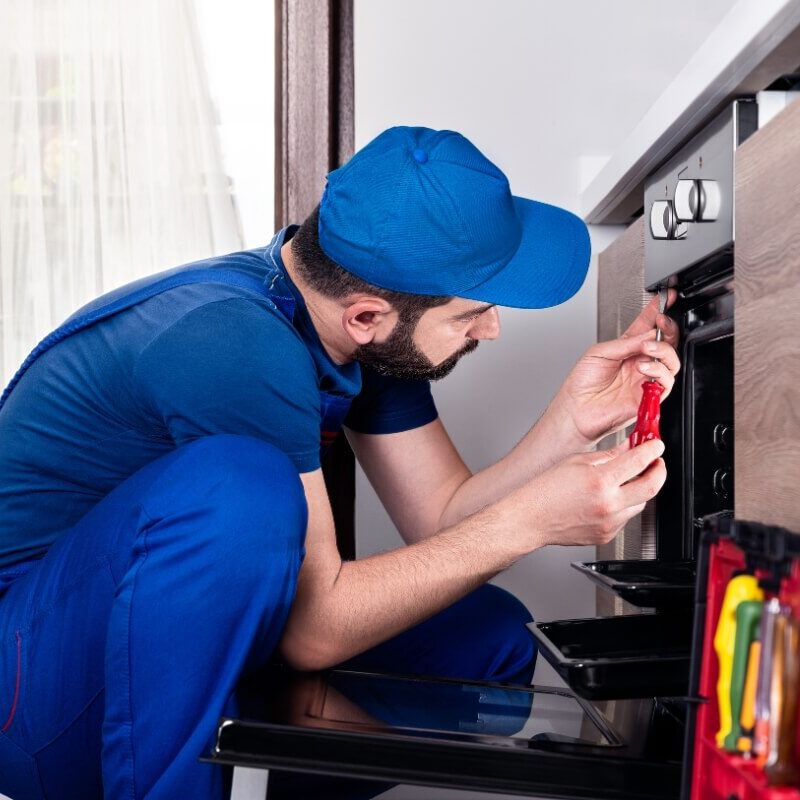 Worker Fixing Stove